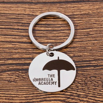 The Umbrella Academy ronde sleutelhanger - Filmspullen.nl
